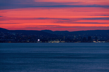 colorful sunset over the port of Novorossiysk on a summer evening