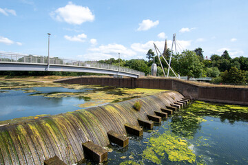 Obraz premium Millers crossing bridge over the river Exe in Exeter. Large mill stones support the structure of the bridge.