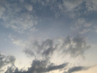 Dramatic sky at sunset with beautiful orange, blue, and grey clouds. A perfect natural background