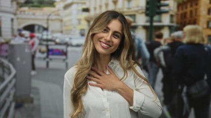 Fototapeta premium Young woman hand on chest on city street; gratitude sincerity.