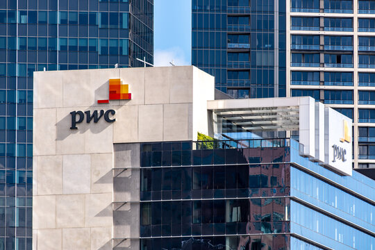 A modern corporate office building featuring the logo of PwC (PricewaterhouseCoopers), one of the Big Four accounting firms, in Melbourne, Australia. 