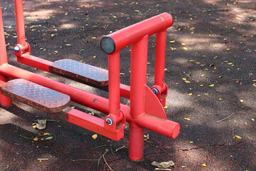 Red air walker exercise machine at a public park. 