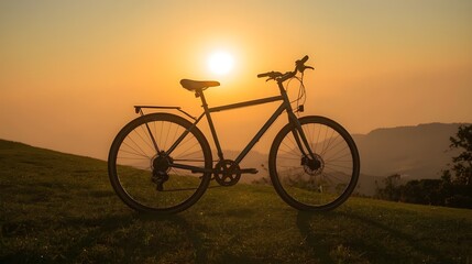 Obraz premium Bicycle on Green Hill at Sunset Lone Bike in Golden Light on Grass
