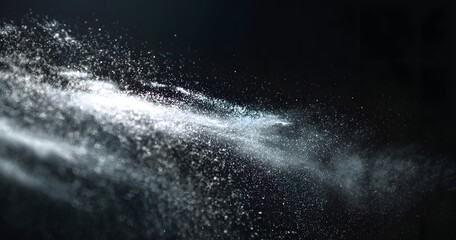 natural dust particles flow in air on black background