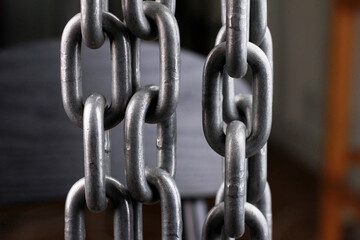 Fototapeta premium Close-up of iron chain on dark background.