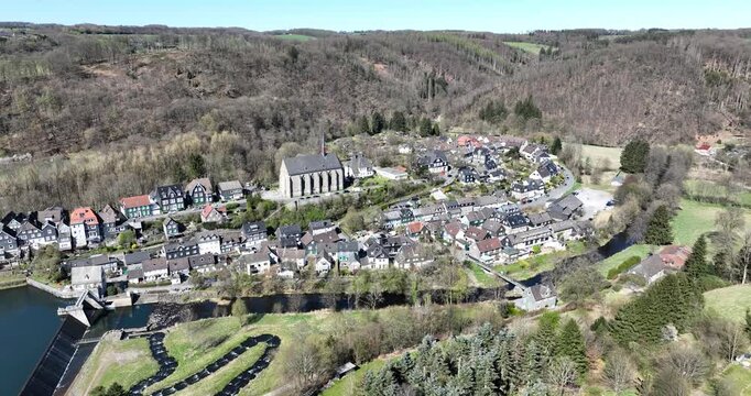 village with Beyenburg chappel cathedral and dam, nestled in a valley of wooded hills in Germany