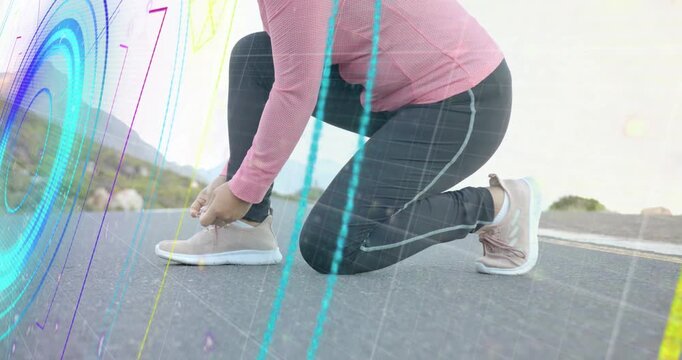 Neon circular animations fading revealing runner tying shoes on mountain road for running workout
