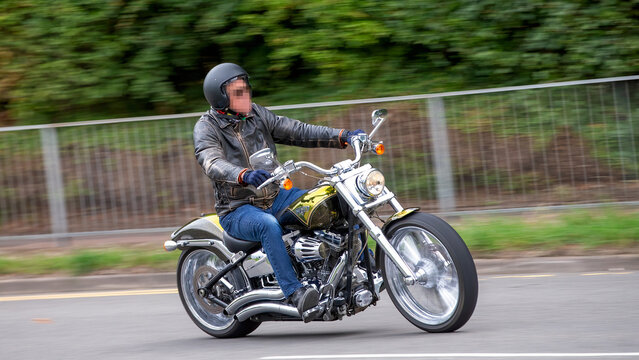 Milton Keynes,Bucks,UK - Aug 3rd 2025:  man riding a 2013 Harley Davidson cvo Breakout  motorcycle travelling on a British road