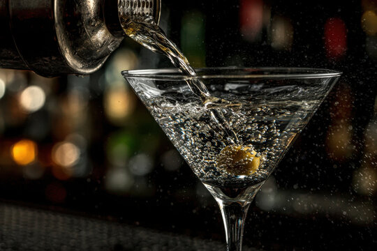 Elegant martini cocktail being poured from a shaker - Powered by Adobe