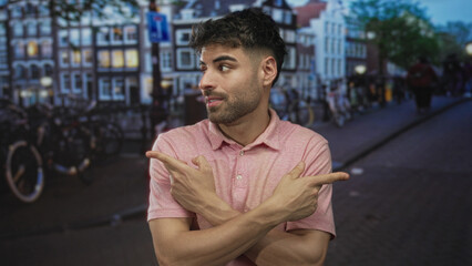Man in pink shirt pointing finger while looking aside amid bicycles on city street; uncertainty...