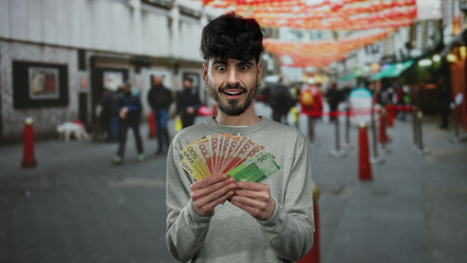 Norwegian man holding banknotes in an urban street scene with blurred pedestrians and vibrant background colors conveying a sense of excitement and prosperity.
