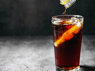 Pouring of Cola and Ice, Cola soft drink with ice cubes, soda fizzy drink in Cold glass