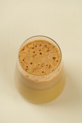 Beautiful Healthy Adaptogenic Drink in Glass, Trendy Vegan Elixir in Kraft Packaging on Rustic Table, Cozy Lifestyle Shot