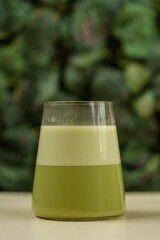 Beautiful Healthy Adaptogenic Drink in Glass, Trendy Vegan Elixir in Kraft Packaging on Rustic Table, Cozy Lifestyle Shot