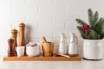 Modern concept of spice and oil storage area on a stylish kitchen marble countertop against a white brick wall. New Year's interior. Front view.