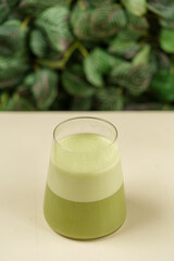 Beautiful Healthy Adaptogenic Drink in Glass, Trendy Vegan Elixir in Kraft Packaging on Rustic Table, Cozy Lifestyle Shot