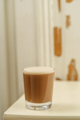 Beautiful Healthy Adaptogenic Drink in Glass, Trendy Vegan Elixir in Kraft Packaging on Rustic Table, Cozy Lifestyle Shot