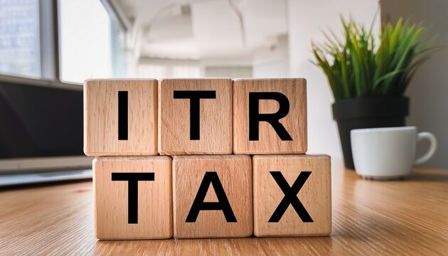 blurred workspace with minimalist wooden block text spelling itr and tax terminology