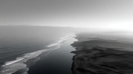 Fototapeta premium Coastal Serenity: An aerial view of a serene coastline in grayscale, where the ocean waves gently meet the shore, evoking feelings of peace and solitude.