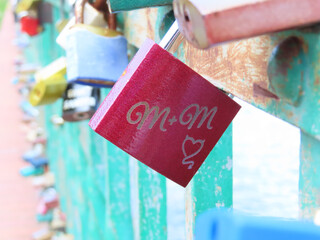 Red love padlock with engraved initials M+M and a heart symbol