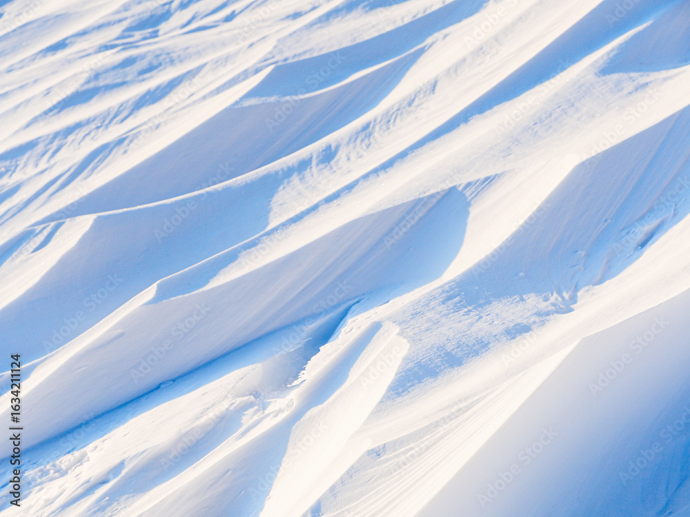 Sticker snow texture. wind sculpted patterns on snow surface. wind in the tundra and in the mountains on the