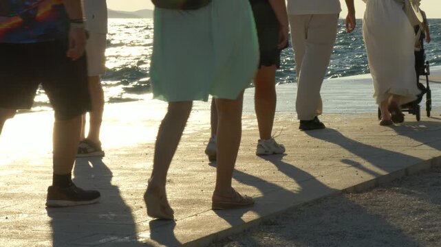 9 Juli 2025 Zadar, Croatia: Feet Walking by the Sea at Sunset