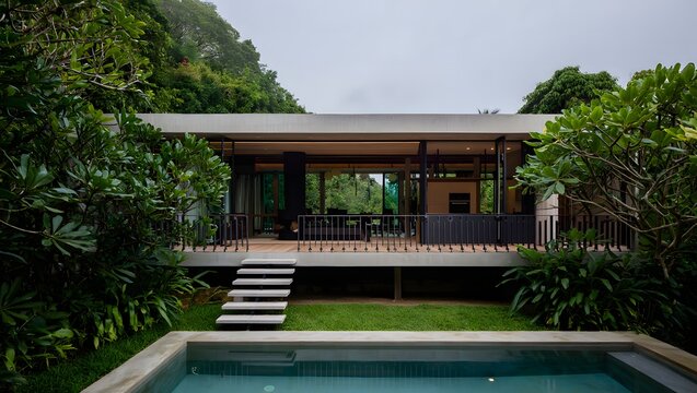 Modern glass house retreat surrounded by lush greenery with a swimming pool - Powered by Adobe