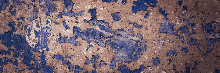 Peeling paint on the wall. Panorama of a concrete wall with old cracked flaking paint. Weathered rough painted surface with patterns of cracks and peeling. Wide panoramic texture for grunge background