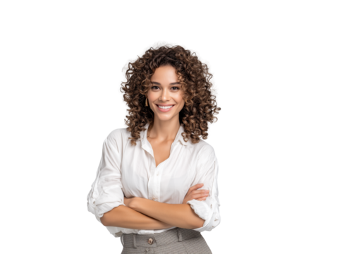 Confident young businesswoman with beautiful curly hair smiling warmly at the camera, standing with arms crossed in a professional white shirt, isolated on a white background for corporate use.