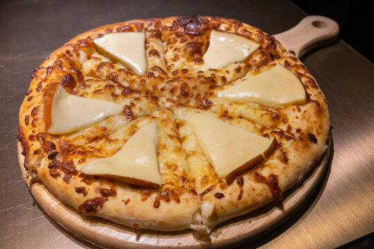 Royal Megruli Khachapuri from Georgia features gouda cheese wedges on top of a cheese filled bread.