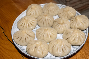 Plate of khinkali, traditional Georgian dumplings, boiled and ready to consume. Khinkali are meat filled dumplings which are a national dish of Georgia.