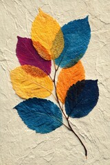 Fototapeta premium Colorful dried leaves arranged on a textured light background