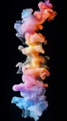 Obraz premium Colorful ink cloud swirling in dark water with blue pink orange and yellow hues abstract background