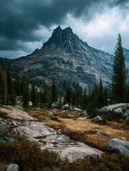 Obraz premium Majestic mountain peak under a dramatic cloudy sky