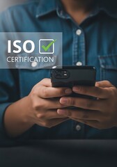 Person holding smartphone with certification graphic