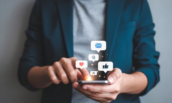 Social Media Interaction: A person in a business suit, focused on their smartphone screen, is surrounded by digital icons, emphasizing online connections and interactions in this digitally driven era.