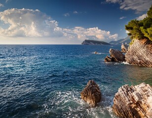 rocky coast of adriatic sea in montenegro with gentle waves and cloudy sky