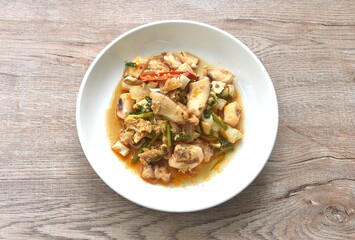 stir-fried spicy squid with salty egg and sauce on dish