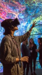 Obraz premium Person wearing VR headset interacting with a colorful digital display