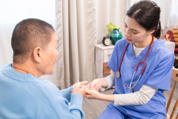 Elderly, caregiver, nurse, patient, support focus on gentle hand massage therapy at home; physiotherapy guidance eases arthritis pain, boosts joint movement, builds trust communication, promotes aging