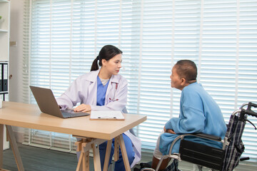 Elderly woman and caregiver or specialist nurse support kneels beside wheelchair, heartfelt conversation build trust communication while holding hands, boosting confidence recovery wellbeing in clinic
