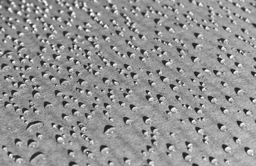 black and white background of drops on cardboard