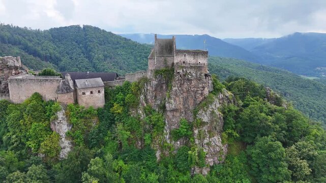 Aggstein Castle on a rocky cliff in Austria, aerial drone orbit

