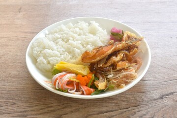 Japanese food bento set grilled salmon fish topping sweet egg and crab stick couple pickled pink ginger and seaweed salad eat couple plain rice on plate