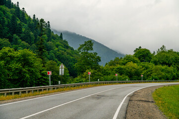 mountain road in the Caucasus to Arkhyz among the mountains in the clouds before rain