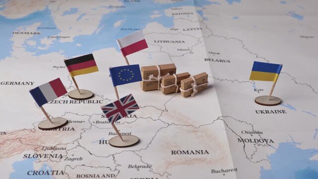 Miniature flags of European countries ( France, Germany, Poland, Ukraine, Britain) and small parcels positioned on a map, symbolizing international trade, global logistics, and economic connections