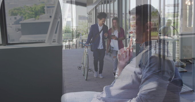 Middle-aged man wearing shirt, talking on smartphone, sitting on lounge bench in office, copy space