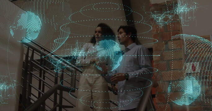 Business professionals examining holographic display on office stairs, with smartphone - Powered by Adobe