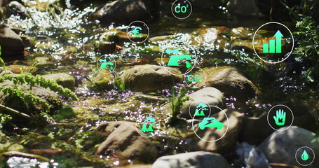 Flowing shallow rocky creek bed glistening in sunlight in woodland, with green data icons