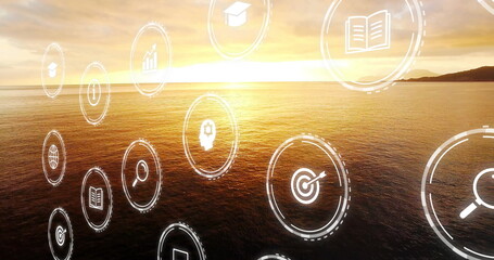 Obraz premium Pływające ikony cyfrowe reprezentujące cele edukacyjne w zakresie czytania, unoszące się nad sylwetką wyspy o zachodzie słońca